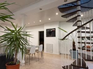 a living room with a staircase and some plants at Gästehaus pack of patches für Familie & Business in Jena