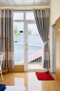 a room with a large window with a view of the ocean at Home Sake Hòn Sơn in Lai Sơn