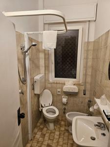 a small bathroom with a toilet and a sink at Hotel La Torre in Cervia +25 photos
