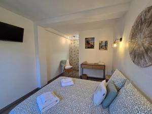 a bedroom with a bed with two towels on it at Chez Louis in Les Issambres