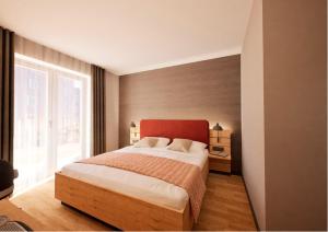 a bedroom with a large bed and a large window at Hotel Adler Äpfingen in Äpfingen