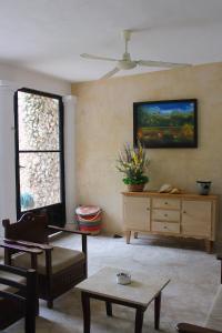a living room with a couch and a painting on the wall at House with pool in downtown Merida, Yucatan in Mérida