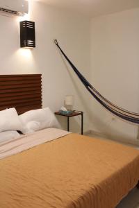 a bedroom with a bed with a brown blanket at House with pool in downtown Merida, Yucatan in Mérida +33 photos