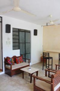a living room with a couch and a table at House with pool in downtown Merida, Yucatan in Mérida