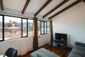 a living room with a view of a city at Hostal & Apartments El Triunfo in Cusco