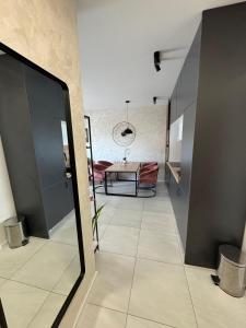 a hallway with a table and a dining room at Apartment Lapis with pool near the beach- by TA Leut Agency in Privlaka +16 photos
