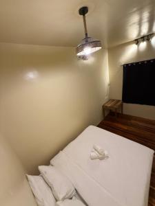 a room with a bed with a phone on it at 9 Keys Inn in San Vicente