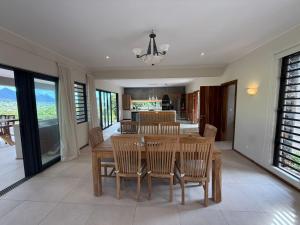 a dining room with a wooden table and chairs at Casa Palmyre in Rivière Noire