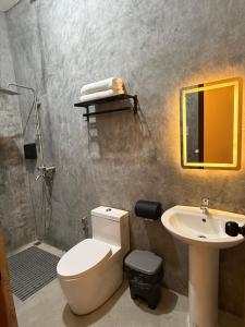 a bathroom with a toilet and a sink at 9 Keys Inn in San Vicente