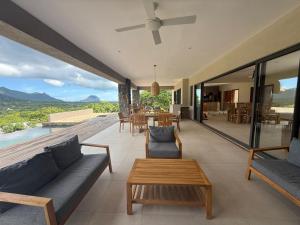 a living room with a couch and a table at Casa Palmyre in Rivière Noire