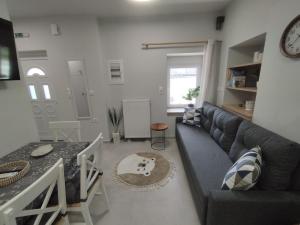 a living room with a couch and a table at KIS Home in Loúros