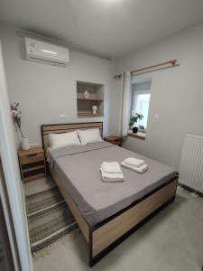 a bedroom with a bed with two towels on it at KIS Home in Loúros