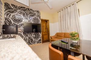 a living room with a couch and a table at We care 4u lodge in Kasoa
