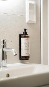 a bottle of soap sitting on a bathroom sink at Hotel Fatima in Trenčín +65 photos