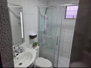 a bathroom with a shower and a toilet and a sink at Habitaciones Express Calama in Calama