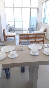 a table with white plates on top of it at OOK Home in Canoas de Punta Sal +5 photos