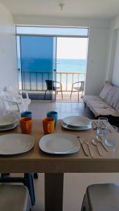 a wooden table with plates and utensils on top of it at OOK Home in Canoas de Punta Sal