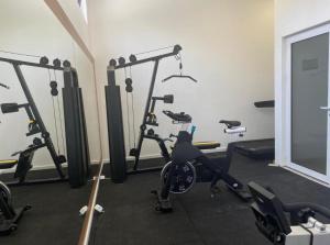 a gym with several exercise bikes in a room at becici residance with pool & sauna in Budva