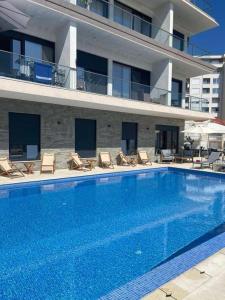a large swimming pool in front of a building at becici residance with pool & sauna in Budva