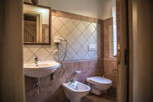 a bathroom with a sink and a toilet and a mirror at Agriturismo Aurea in Torretta +39 photos