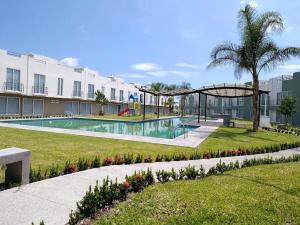 a swimming pool with a playground in a building at La Casa de Coco in Tlayacapan