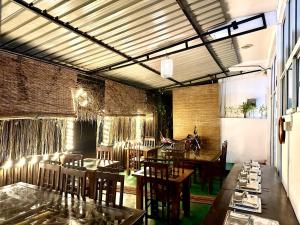 a restaurant with tables and chairs in a room at Ella Nature Life Guest & Restaurant -Free Pickup from Ella in Ella