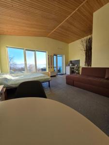 a living room with a bed and a couch at LeGora in Pryborzhavsʼke