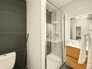 a bathroom with a shower and a toilet and a sink at Le Vercors in Valence