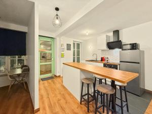a kitchen with a wooden counter top and a refrigerator at Le Vercors in Valence
