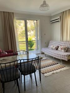 a living room with a table and chairs and a couch at Mermaid in Marmaris