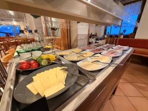 a buffet with cheese and vegetables on a table at Gasthof Und Hotel Maria Gern in Berchtesgaden