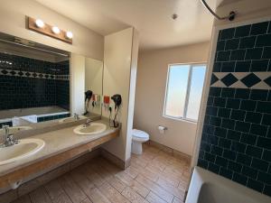 a bathroom with two sinks and a mirror at SurfSide Stay in Morro Bay