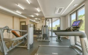a gym with tread machines and a treadmill at Coastal Residences by In Property in Bečići