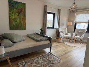 a bedroom with a bed and a living room at WohlfühlWerk L4 in Mechernich
