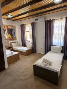 a bedroom with two beds in a room at Guest house Afsona old city in Bukhara