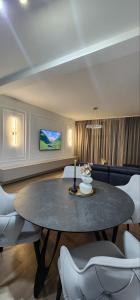 a dining room with a table and a tv at NOIR Luxury in Trebinje