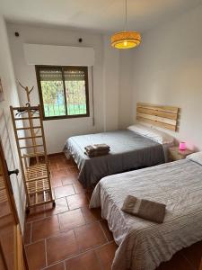 a room with two beds and a ladder in it at VILLA LÚA in Cartaya +23 photos