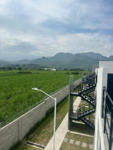 a balcony of a building with a view of a field at La Casa de Coco in Tlayacapan
