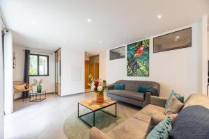 a living room with a couch and a table at Casa u fornu Residence & Spa in LʼÎle-Rousse