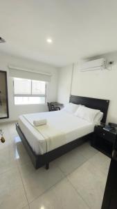 a bedroom with a large bed in a room at Nacar Boutique hotel in Valledupar