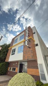 a building with a sign on the side of it at Nacar Boutique hotel in Valledupar