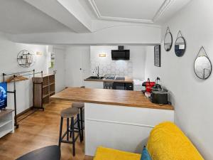 a kitchen with a counter top in a room at Sous Les Toits in Valence