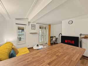a living room with a couch and a table at Sous Les Toits in Valence