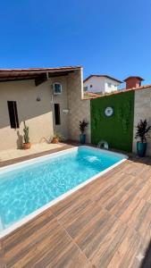 a swimming pool in front of a house at Casarão do Mar in Cabo Frio