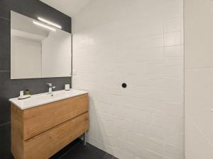 a bathroom with a sink and a mirror at Sous Les Toits in Valence