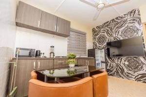 a kitchen with a table and chairs in a room at We care 4u lodge in Kasoa