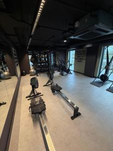 a gym with several exercise equipment in a room at Berkeley Square Apartments by StaySavvy Accommodation in Manchester