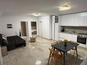 a living room with a couch and a table at Casa Florescu in Craiova +24 photos