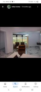 a picture of a living room with a table and chairs at Hotel shree ji in Lucknow +2 photos