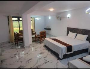 a hotel room with a bed and a table and chairs at Hotel shree ji in Lucknow